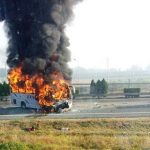 A tourist bus, seen through the window of a vehicle, catches fire after crashing with a truck on the Beijing-Tianjin-Tanggu Expressway in Tianjin October 1, 2012. According to local reports, the incident killed six, including five Germans and injured 14. REUTERS/Peng Jianfeng