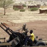 A SPLA-N fighter sits with an anti-aircraft weapon near Jebel Kwo village in the rebel-held territory of the Nuba Mountains in South Kordofan, May 2, 2012. REUTERS/Goran Tomasevic