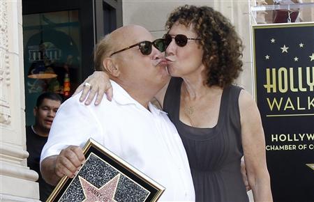 Actor Danny DeVito and his wife Rhea Perlman kiss as they pose on his star after it was unveiled on the Walk of Fame in Hollywood, California in this August 18, 2011 file photo. REUTERS/Mario Anzuoni/Files