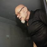 British 'glam rocker' Gary Glitter stands inside a police truck before being taken to prison after the verdict in Vung Tau, a resort town 120 km (75 miles) southeast of Ho Chi Minh City in this March 3, 2006 file photo. REUTERS/Zainal Abd Halim/Files
