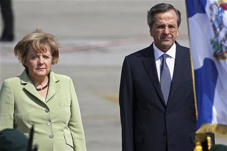 Germany's Chancellor Angela Merkel is welcomed by Greece's Prime Minister Antonis Samaras (R) upon arrival at Eleftherios Venizelos airport near Athens October 9, 2012. REUTERS/Dimitris Doudoumis//ICON