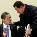 Venezuela's President Hugo Chavez, right, hands President Barack Obama