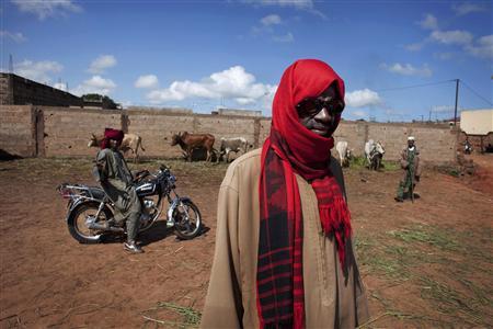 Cattle herder Modibo Diallo poses for a picture at a cattle market in Bobo Dioulasso Cattle herder Modibo Diallo poses for a picture at a cattle market in Bobo Dioulasso, Burkina Faso, September 24 2012. Picture taken September 24, 2012. REUTERS/Joe Penney