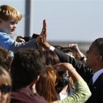 U.S. President Barack Obama high-fives with Max Frank, 4 years old, from Livermore after Obama arrives at San Francisco International Airport to continue a three day campaign swing in California and Ohio, October 8, 2012. REUTERS/Larry Downing