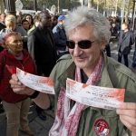 A Rolling Stones fan displays two tickets he purchased for a short warm-up gig in Paris October 25, 2012 as the group prepares for a series of 50th anniversary concerts later this year. REUTERS/Philippe Wojazer