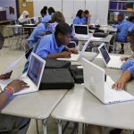 Students at the Lilla G. Frederick Pilot Middle School work on their laptops during a class in Dorchester, Massachusetts June 20, 2008. REUTERS/Adam Hunger