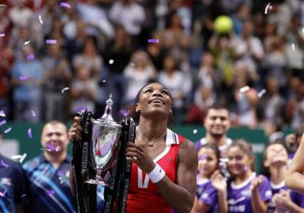 Serena Williams of the U.S. celebrates with the trophy after her victory against Russia's Maria Sharapova after their final WTA tennis championships match in Istanbul, October 28, 2012. REUTERS/Osman Orsal
