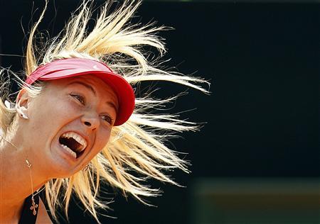 Maria Sharapova of Russia serves to Angelique Kerber of Germany during their women's singles semi-final match at the Rome Masters tennis tournament in this May 19, 2012 file photo. Plans to muzzle the ear-bashing grunters of women's tennis have found an unlikely ally in Sharapova. One of the worst offenders, her screams have been measured at more than 101 decibels - comparable to a chain saw, a pneumatic drill or a speeding train. The sport's governing body is to educate players to turn down the volume after pressure from fans, TV broadcasters and a handful of competitors fed up with the constant shrieking on court - and Sharapova thinks it is the right answer. REUTERS/Alessandro Bianchi/Files