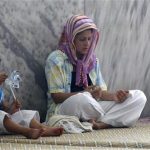 A Turkish Alawite woman prays as she visits a tomb, a holy site for the Alawite community, with her child in the Samandag district of Hatay province, close to the border with Syria, July 27, 2012. An influx of Syrians fleeing President Bashar al-Assad's military onslaught is stoking tension in the area of Turkey known for religious tolerance and setting Turks who share the Syrian leader's creed against their own government. In the Turkish frontier province of Hatay, home to the Antioch of the Bible and a mix of confessional groups rare in an overwhelmingly Sunni Muslim country, Turks of Arab origin who share Assad's Alawite beliefs are increasingly critical of Ankara's open support for rebels fighting the Syrian leader. Picture taken July 27, 2012. REUTERS/Umit Bektas
