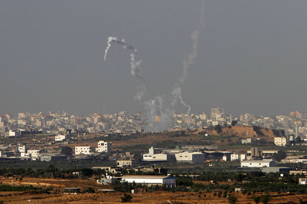 Trails of smoke are seen after the launch of rockets from the northern Gaza strip towards Israel this morning. Photograph: Amir Cohen/Reuters