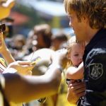 Larry Birkhead, ex-boyfriend of the late Anna Nicole Smith, holds his daughter Dannielynn as he is being interviewed at the opening of The Simpsons Ride at Universal Studios Hollywood in Universal City, California May 17, 2008. REUTERS/Mario Anzuoni