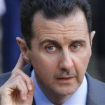 Syria's President Bashar al-Assad answers journalists after a meeting at the Elysee Palace in Paris, December 9, 2010. REUTERS/Benoit Tessier