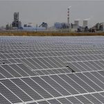 A solar power plant is seen near a thermal power plant in Aksu, Xinjiang Uyghur Autonomous Region May 18, 2012. REUTERS/Stringer