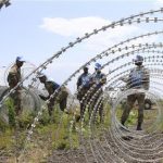 The South Africa contingent of the U.N. peacekeepers in Congo erect a razor wire barrier around Goma airport in the Democratic Republic of Congo November 26, 2012. REUTERS/James Akena