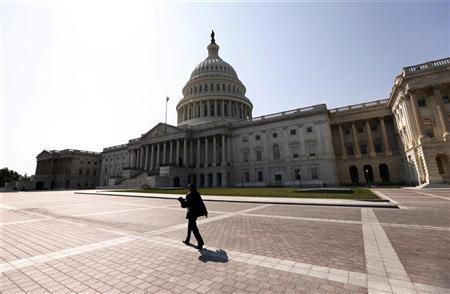A woman walks past the U.S. Capitol in Washington A woman walks past the U.S. Capitol in Washington September 25, 2012. REUTERS/Kevin Lamarque