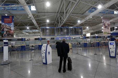 A passenger looks at an announcement board inside the Athens Eleftherios Venizelos airport a few hours before a work stoppage by flight controllers begins in Athens A passenger looks at an announcement board inside the Athens Eleftherios Venizelos airport a few hours before a work stoppage by flight controllers begins in Athens November 6, 2012. Greek workers begin a 48-hour strike on Tuesday to protest against a new round of austerity cuts that unions say will devastate the poor and drive a failing economy to collapse. REUTERS/John Kolesidis
