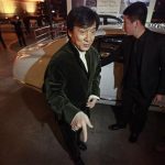 Kung Fu superstar Jackie Chan gestures in front of a car before having his Bentley 666 auctioned for charity in Beijing, November 19, 2012. Chan said that while the upcoming film "Chinese Zodiac 2012" will be his last major action movie, citing his increasing age, he will still be packing punches in the world of philanthropy. Chan wrote, directed and produced his latest film, set to premiere in cinemas next month. He also plays the lead role and said that it was probably his "best film for myself" in the last ten years. Picture taken November 19, 2012. REUTERS/Petar Kujundzic