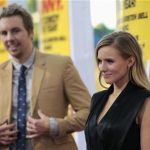 Cast member Kristen Bell poses, as her fiance and co-star Dax Shepard watches, at the premiere of "Hit and Run" at Regal Cinemas in Los Angeles, California August 14, 2012. REUTERS/Mario Anzuoni