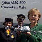 German Chancellor Angela Merkel holds a scale model of an Airbus A380 aircraft as she poses for the media in front of a new Airbus A380 aircraft of Lufthansa during her opening tour at the ILA International Air Show in Schoenefeld, south of Berlin, in this June 8, 2010 file picture. REUTERS/Thomas Peter/Files