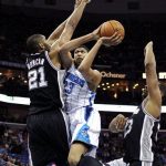 New Orleans Hornets power forward Anthony Davis (23) drives to the basket against San Antonio Spurs power forward Tim Duncan (21) in the first half of an NBA basketball game in New Orleans, Wednesday, Oct. 31, 2012. (AP Photo/Gerald Herbert)