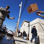 Soldiers from the National Guard help to unload supplies to set up a donation distribution center for victims of superstorm Sandy at St. Camillus School in the Rockaways area of the Queens borough of New York, November 4, 2012. REUTERS/Lucas Jackson