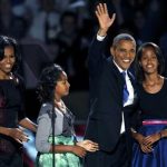 U.S. President Barack Obama, who won a second term in office by defeating Republican presidential nominee Mitt Romney, waves with his daughters Malia (R) and Sasha and wife Michelle (L) before addressing supporters during his election night victory rally in Chicago, November 7, 2012. REUTERS/Jeff Haynes