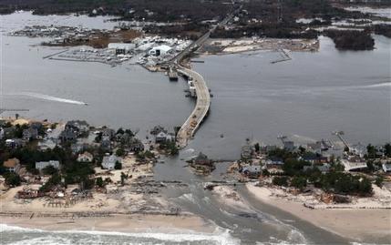 This aerial photo made from a helicopter shows storm damage from Sandy over the Atlantic Coast in Mantoloking, N.J., Wednesday, Oct. 31, 2012. The photo was made from a helicopter behind the helicopter carrying President Obama and New Jersey Gov. Chris Christie, as they viewed storm damage from superstorm Sandy.   (AP Photo/Doug Mills, Pool)