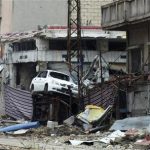 Damaged cars are seen near a curtain erected as protection from snipers loyal to Syria's President Bashar al-Assad, at the al-Khalidiya neighbourhood of Homs November 24, 2012. Picture taken November 24, 2012. REUTERS/Yazan Homsy