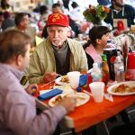 People eat a Thanksgiving dinner cooked and served by volunteers in the Staten Island borough of New York November 22, 2012. REUTERS/Eric Thayer