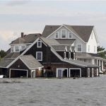 A partially submerged house is pictured as Governor Chris Christie, Secretary of Transportation Ray Lahood and Lt. Governor Kim Guadagno surveyed the superstorm Sandy damaged areas of Barnegat Bay by boat off of Mantoloking, New Jersey in this November 2, 2012 handout photo. REUTERS/Governor's Office/Tim Larsen/Handout