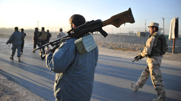 Afghan-security-forces-patrol-the-site-where-Taliban-suicide-bombers-attacked-a-U.S.-Afghan-base-in-Jalalabad-east-of-Kabul