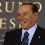 Former Italian Prime Minister Silvio Berlusconi smiles as he arrives to attend the book launch of his friend, TV presenter Bruno Vespa, in Rome December 12, 2012. REUTERS/Tony Gentile