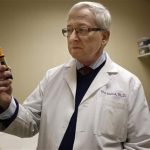 Dr. Mark Molitch of Northwestern University, who helped write medical standards meant to limit HGH treatment to legitimate patients, holds an injector pen that contains approximately a weeks worth of doses for a patient in need of the drug at his clinic Thursday, Dec. 20, 2012, in Chicago. An Associated Press investigation shows that a federal crackdown on illicit foreign supplies of human growth hormone has failed to stop rampant misuse, and instead has driven record sales of the drug by some of the world's biggest pharmaceutical companies. (AP Photo/M. Spencer Green)