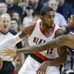 Portland Trail Blazers forward LaMarcus Aldridge, left, works the ball in against Sacramento Kings forward James Johnson during the first quarter of an NBA basketball game in Portland, Ore., Wednesday, Dec. 26, 2012. (AP Photo/Don Ryan)