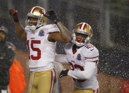 San Francisco 49ers wide receiver Michael Crabtree (L) celebrates his touchdown against the New England Patriots with 49ers team mate LaMichael James during the second half of their NFL football game in Foxborough, Massachusetts December 16, 2012. REUTERS/Jessica Rinaldi