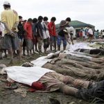 Bodies of flash flood victims lie on the ground as villagers look for their missing relatives after Typhoon Bopha hit New Bataan in Compostela province, southern Philippines December 5, 2012. REUTERS/Stringer