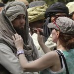 A crew member of Oscar-winning director Kathryn Bigelow's team for the movie "Zero Dark Thirty" applies makeup on an actor during a shoot at the filming location in the northern Indian city of Chandigarh March 17, 2012. REUTERS/Ajay Verma