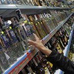 A customer takes a bottle of vodka from a shelf at a Russian supermarket in Benidorm, November 26, 2012. REUTERS/Heino Kalis