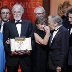 Director Michael Haneke (2ndL), actress Emmanuelle Riva (L) and actor Jean-Louis Trintignant (2ndR) react after receiving the Palme d'Or award for the film "Amour" (Love) during the awards ceremony of the 65th Cannes Film Festival, May 27, 2012. REUTERS/Eric Gaillard