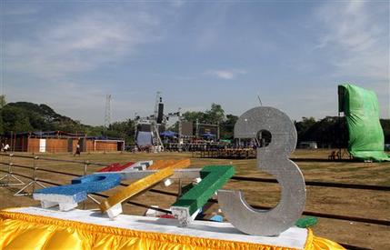 Myanmar New Year Workers set up a stage as preparations are underway for the country's first ever public New Year's countdown celebration, at Myoma grounds in Yangon, Myanmar, Monday, Dec. 31, 2012. (AP Photo/Khin Maung Win)