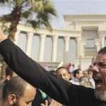 A supporter of Egypt's President Mohamed Mursi gestures during a rally in front of the Supreme Constitutional Court in Maadi, south of Cairo, December 2, 2012. REUTERS/Amr Abdallah Dalsh