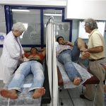 Doctors examine patients at a medical centre of the Greek delegation of the Doctors of the World in Athens May 31, 2012. REUTERS/Yorgos Karahalis
