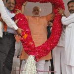 Gujarat's Chief Minister Narendra Modi (C) receives a rose garland by his supporters during an election campaign rally ahead of the state assembly elections at Fagvel village in the western Indian state of Gujarat October 11, 2012. REUTERS/Amit Dave