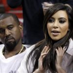 FILE - Kim Kardashian, right, and Kanye West, left, are shown before an NBA basketball game between the Miami Heat and the New York Knicks in this Dec, 6, 2012 file photo taken in Miami. The rapper Kanye West announced at a concert Sunday night Dec. 30, 2012 that his girlfriend is pregnant. He told the crowd of more than 5,000 at the Ovation Hall at the Revel Resort in song form: "Now you having my baby." ( AP Photo/Alan Diaz, File)