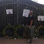 A Libyan government militia guarding the main entrance of the U.S. consulate that was attacked last week, fixes a note written by Libyans against the attack, in Benghazi city September 18, 2012. REUTERS/Asmaa Waguih