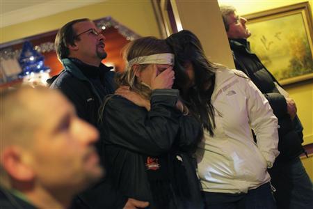 A woman covers her face as she watches U.S. President Obama speak on a television with other patrons, at Church Hill restaurant in Newtown, Connecticut A woman covers her face as she watches U.S. President Barack Obama speak on a television with other patrons, at Church Hill restaurant in Newtown, Connecticut December 16, 2012. REUTERS/Joshua Lott
