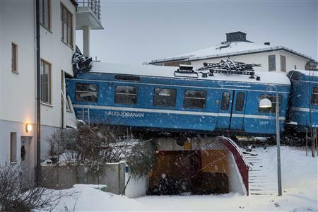 A local train that derailed and crashed into a residential building in Saltsjobaden is seen outside Stockholm in this picture taken by Scanpix Sweden January 15, 2013. According to local media, a spokesman from Arriva, the company that operates the train line, says the train was stolen by a domestic cleaner, who stole the train for unknown reasons. The cleaner was taken to a hospital after the crash. No residents in the building were injured. REUTERS/Jonas Ekstromer/Scanpix Sweden