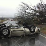 A vehicle lies on a road after a tornado moved through Adairsville, Ga. on Wednesday, Jan. 30, 2013. A fierce storm system that roared across northwest Georgia has left at least one person dead and a trail of damage that included demolished buildings in downtown Adairsville and vehicles overturned on Interstate 75 northwest of Atlanta. (AP Photo/David Goldman)