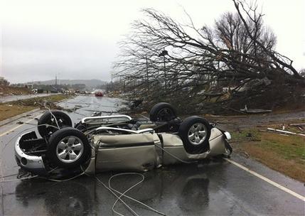 A vehicle lies on a road after a tornado moved through Adairsville, Ga. on Wednesday, Jan. 30, 2013. A fierce storm system that roared across northwest Georgia has left at least one person dead and a trail of damage that included demolished buildings in downtown Adairsville and vehicles overturned on Interstate 75 northwest of Atlanta. (AP Photo/David Goldman)
