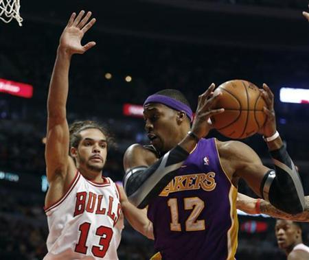 Chicago Bulls center Joakim Noah (13) defends against Los Angeles Lakers center Dwight Howard during the first half of their NBA basketball game in Chicago, Illinois January 21, 2013. REUTERS/Jeff Haynes